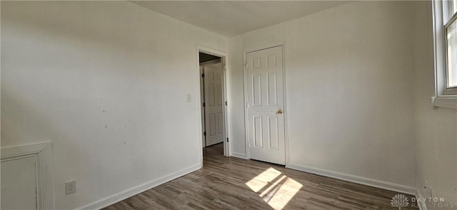 empty room featuring baseboards and wood finished floors