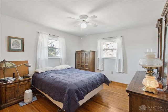 bedroom with light wood-type flooring and a ceiling fan