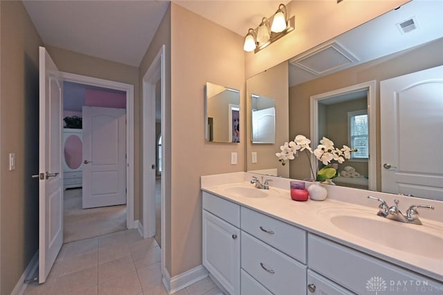 full bathroom featuring a sink, visible vents, double vanity, and tile patterned floors