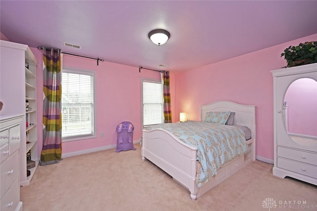 bedroom with light colored carpet, visible vents, and baseboards