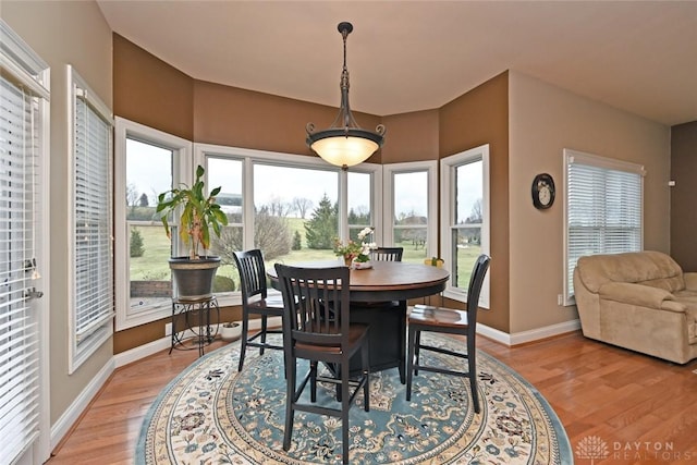 dining room featuring light wood-style flooring and baseboards