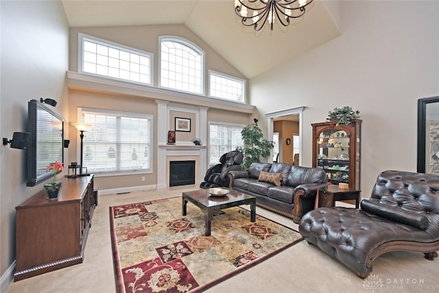 living room with an inviting chandelier, a fireplace, a wealth of natural light, and light carpet