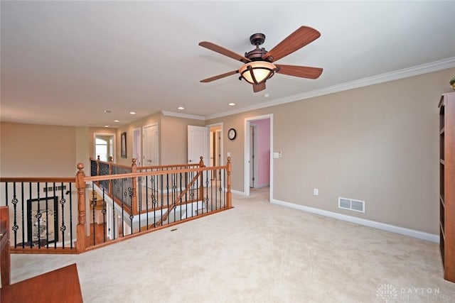 carpeted empty room featuring visible vents, ornamental molding, recessed lighting, baseboards, and ceiling fan