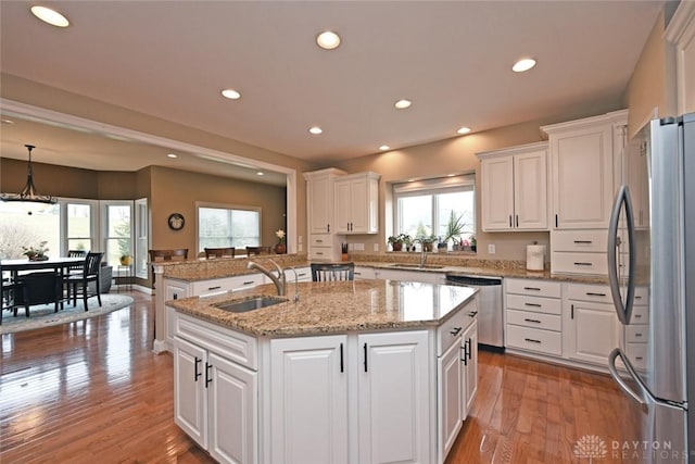 kitchen featuring white cabinetry, plenty of natural light, appliances with stainless steel finishes, and a sink