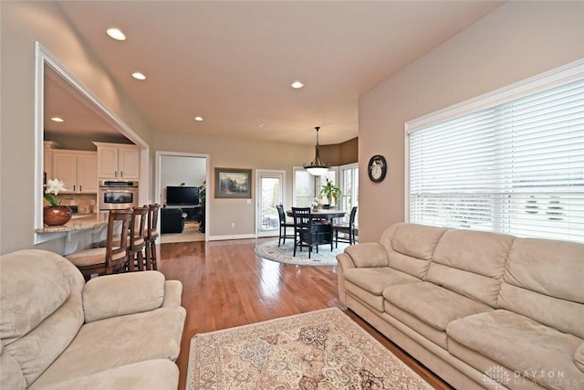 living room featuring recessed lighting, wood finished floors, and baseboards