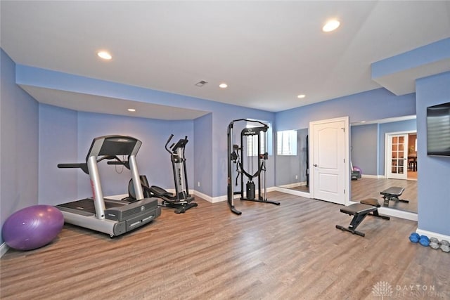 workout area with recessed lighting, baseboards, and wood finished floors