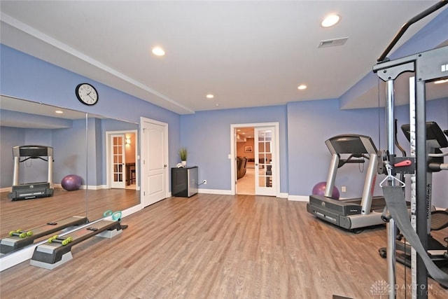 workout area with visible vents, recessed lighting, french doors, and wood finished floors