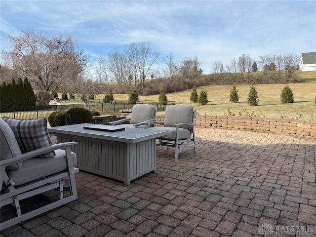 view of patio featuring a fire pit and fence