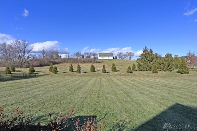 view of yard with a rural view and fence