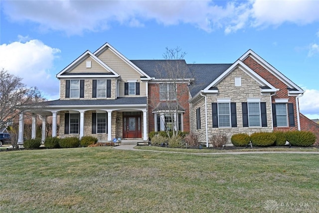 view of front facade featuring stone siding, covered porch, and a front lawn