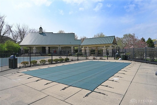 community pool featuring a patio and fence