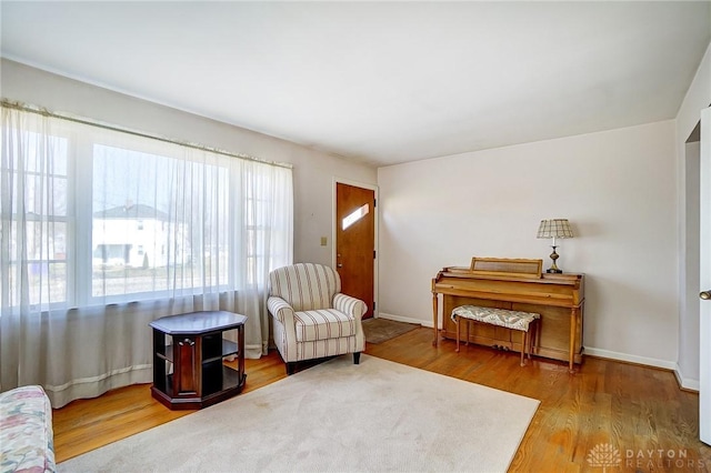 sitting room featuring baseboards and wood finished floors