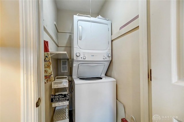 laundry area with stacked washer and dryer and laundry area