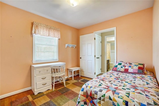 bedroom with wood finished floors and baseboards