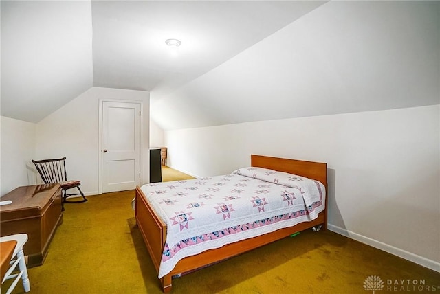 bedroom featuring baseboards, carpet floors, and vaulted ceiling