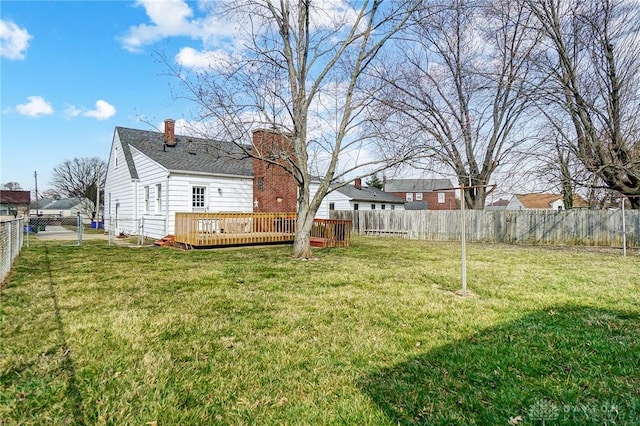 view of yard with a fenced backyard and a deck