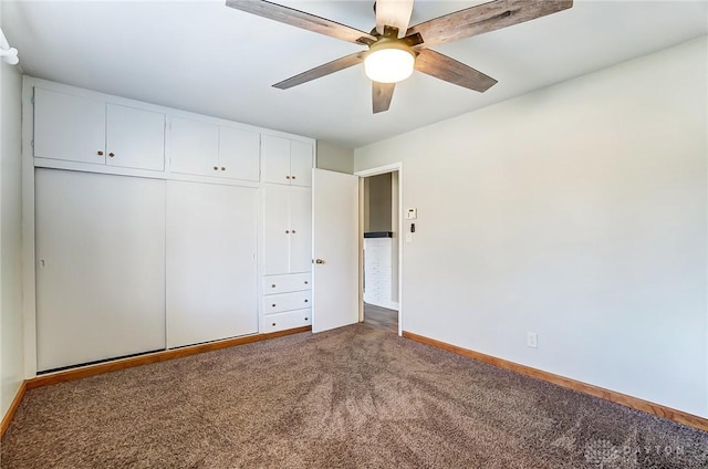 unfurnished bedroom with a closet, carpet flooring, a ceiling fan, and baseboards