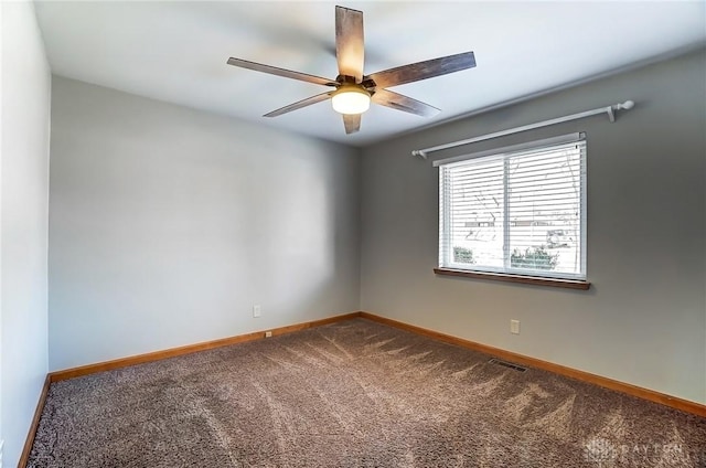 unfurnished room with visible vents, baseboards, carpet, and ceiling fan