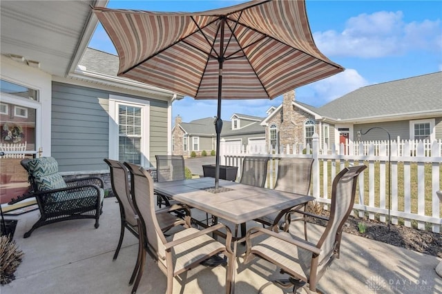 view of patio featuring outdoor dining area and fence