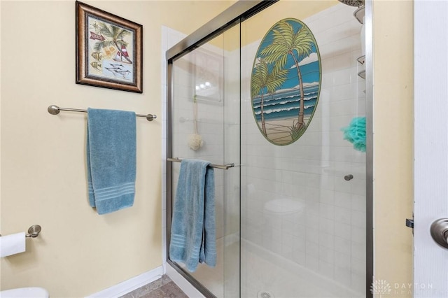 full bath featuring baseboards and a stall shower