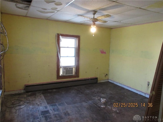 empty room with cooling unit, a paneled ceiling, baseboard heating, and a ceiling fan