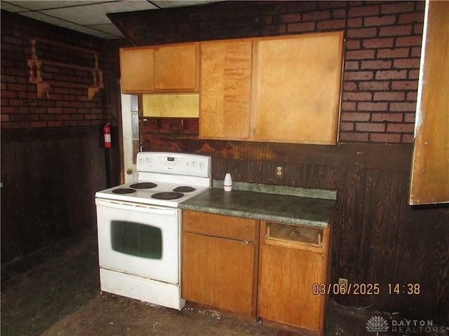 kitchen featuring dark countertops, electric range, and a drop ceiling