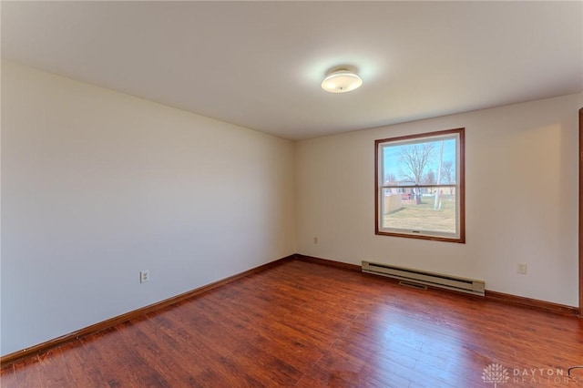 unfurnished room with wood finished floors, baseboards, and a baseboard radiator