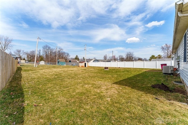 view of yard with cooling unit and a fenced backyard