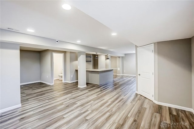 unfurnished living room featuring recessed lighting, visible vents, light wood-type flooring, and baseboards