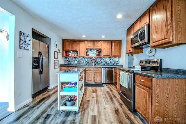 kitchen with brown cabinetry, appliances with stainless steel finishes, and open shelves