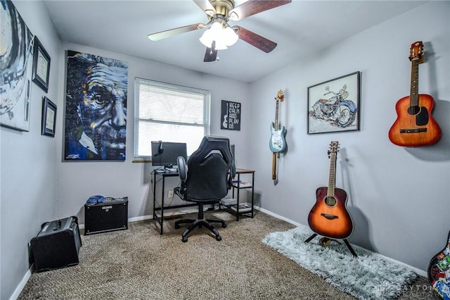 carpeted office featuring baseboards and a ceiling fan