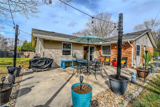 back of property featuring a patio and fence