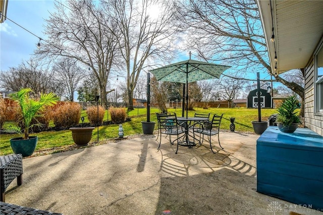 view of patio with an outdoor structure and outdoor dining space