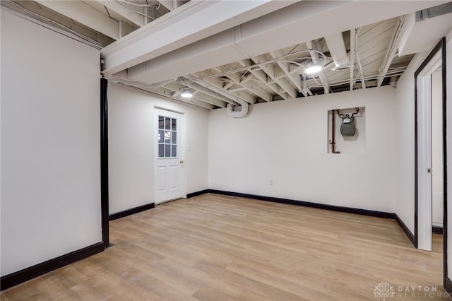 finished below grade area featuring light wood-style flooring and baseboards