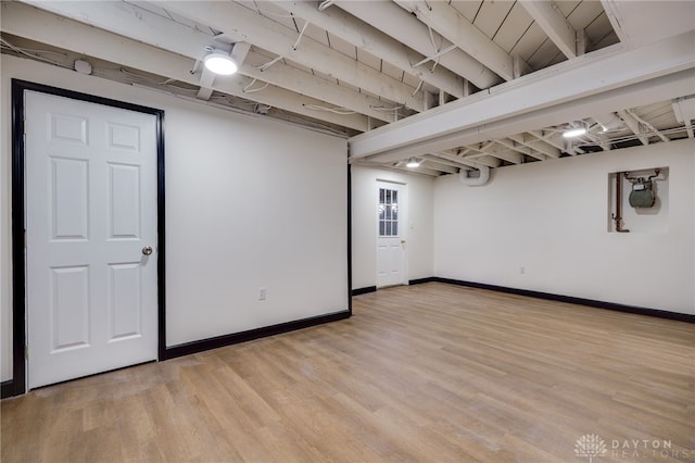 finished below grade area featuring light wood-type flooring and baseboards