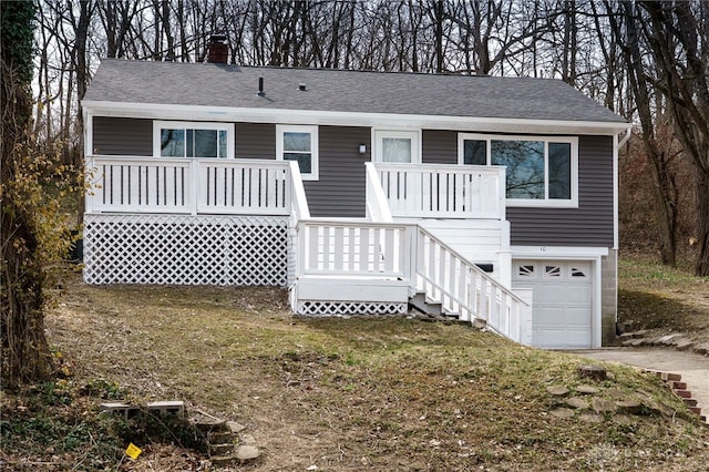 view of front facade featuring a front lawn, an attached garage, roof with shingles, and a chimney