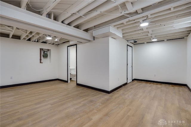 finished basement with light wood-style flooring and baseboards