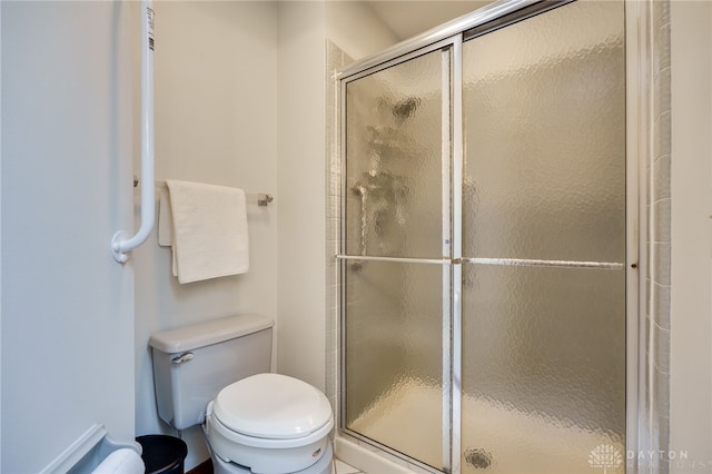 full bath featuring a stall shower and toilet