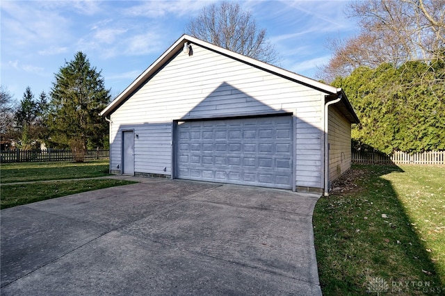 detached garage featuring fence