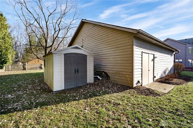 view of shed featuring fence