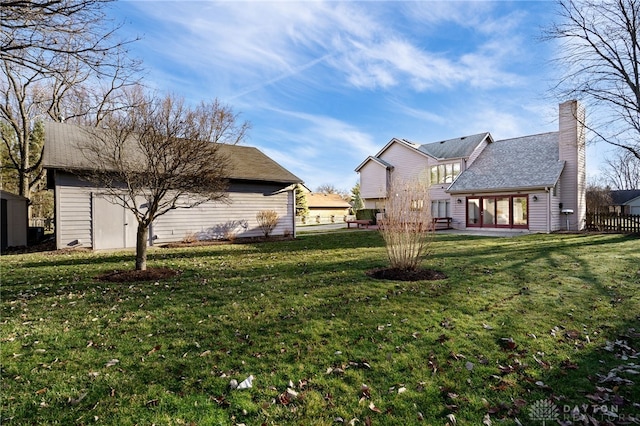 view of yard featuring a patio and an outbuilding