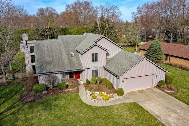 view of front of property featuring a chimney, a shingled roof, a front lawn, concrete driveway, and a garage