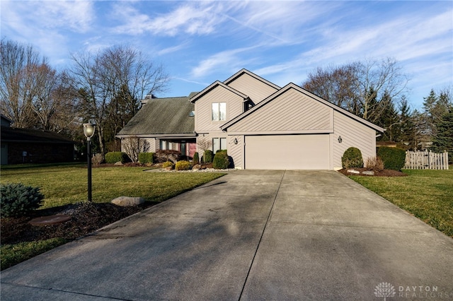 view of front of home featuring a garage, driveway, a front lawn, and fence