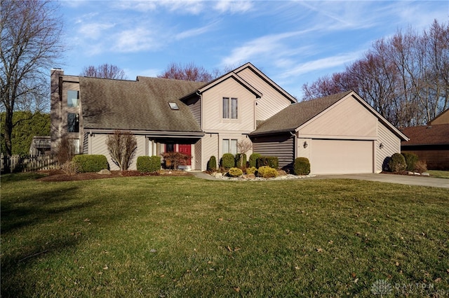 traditional-style house featuring a front lawn, an attached garage, and driveway