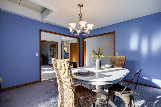 tiled dining area featuring baseboards, carpet floors, and a chandelier