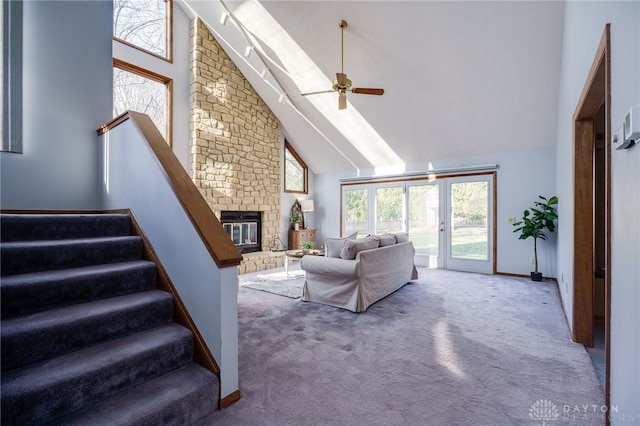 living room featuring high vaulted ceiling, carpet, and a ceiling fan