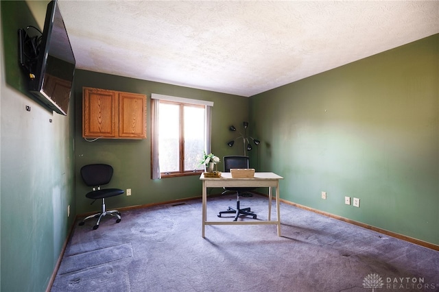 carpeted office space with baseboards and a textured ceiling