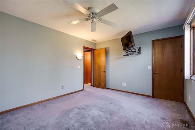 unfurnished bedroom featuring visible vents, baseboards, and carpet flooring