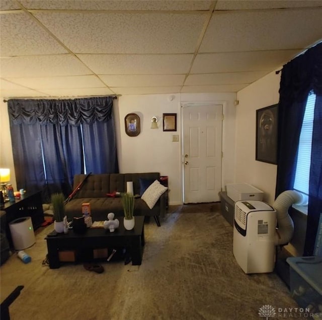 living room with a drop ceiling