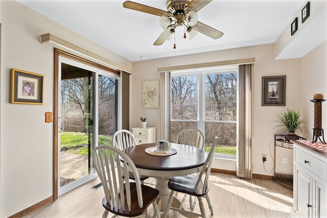 dining area with baseboards, a healthy amount of sunlight, light wood-type flooring, and ceiling fan